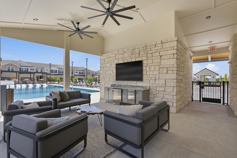 Rendering of open game lawn at HARMON Melissa with townhomes in the background